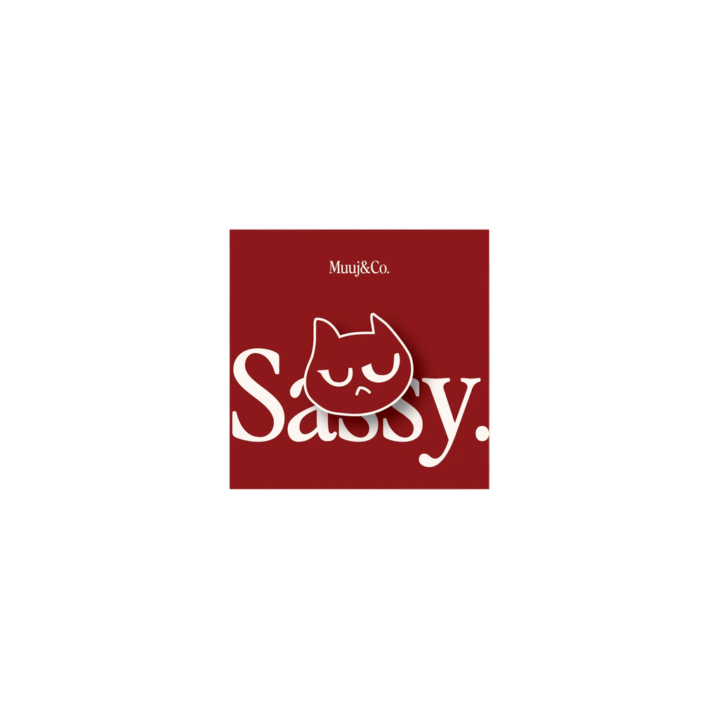 A square red sticker or decal featuring the white text 'Sassy.' and a white cartoon cat face, shown on a plain white background.