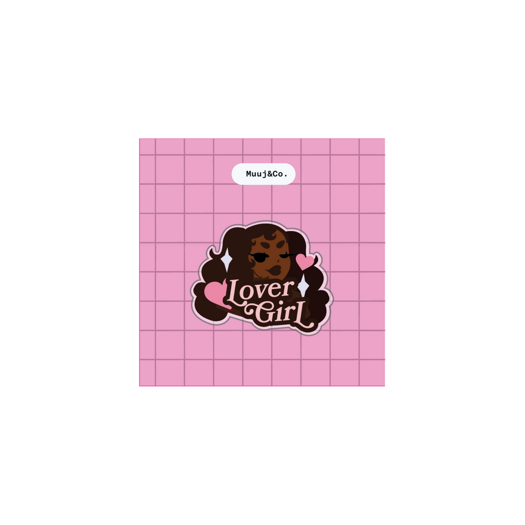 A square pink grid-patterned card or sticker featuring a central cartoon-style face with dark hair, pink hearts, and the words 'Lover Girl' in stylized lettering. A small label at the top reads 'MuxJ6Co.